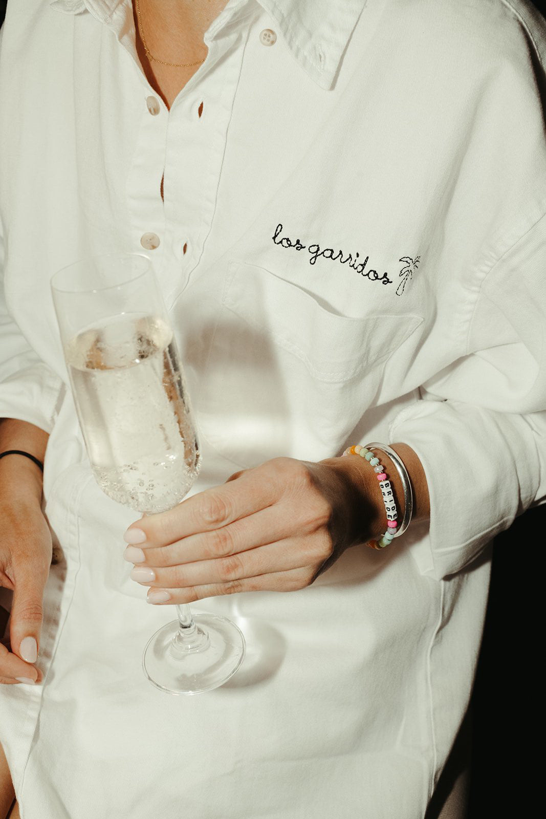 Personalized bridal gifts and bachelorette party outfits, including embroidered button downs, pajamas and robes