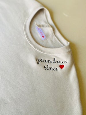 Beige tank top with 'grandma rina' text and red heart on a beige background