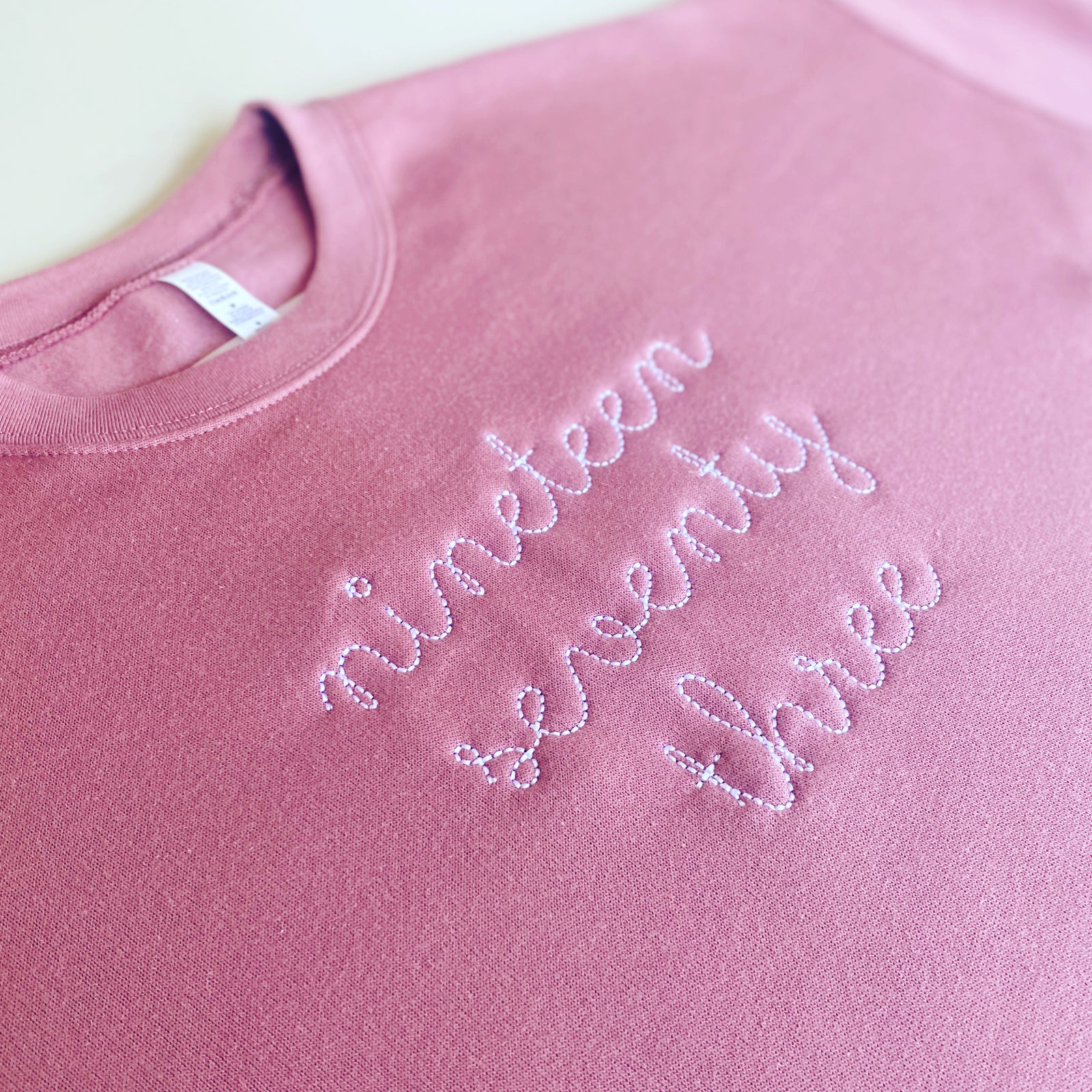 Womens crewneck fleece with 1973 embroidered text.