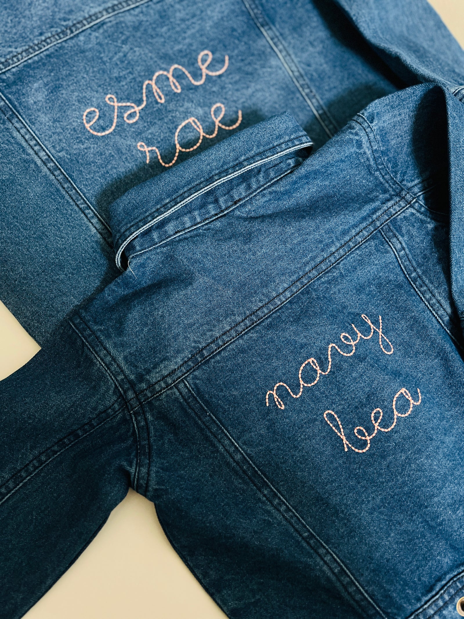 Baby personalized denim jacket with custom embroidered name on front.
