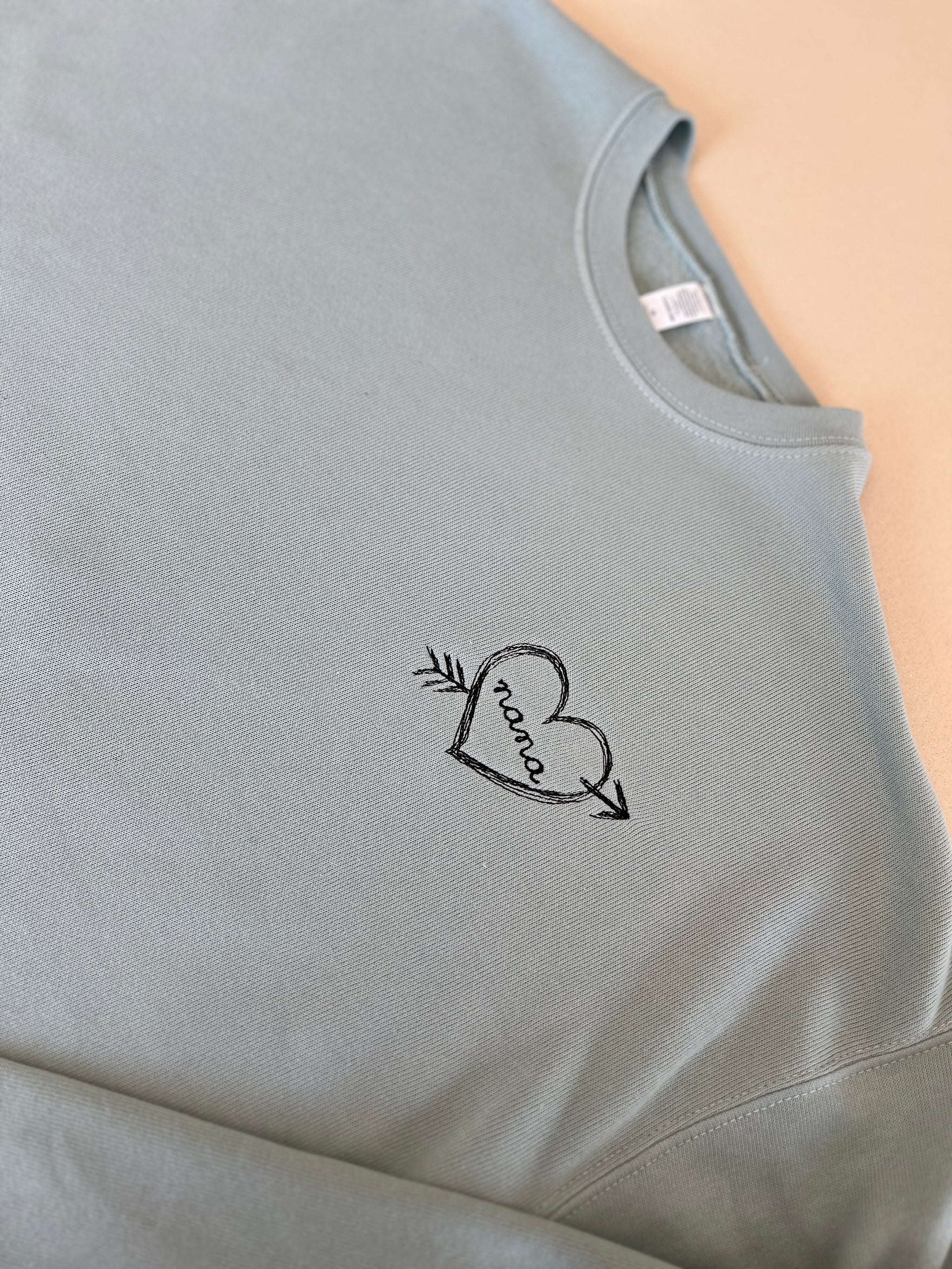 Personalized sweatshirt with heart and arrow embroidery