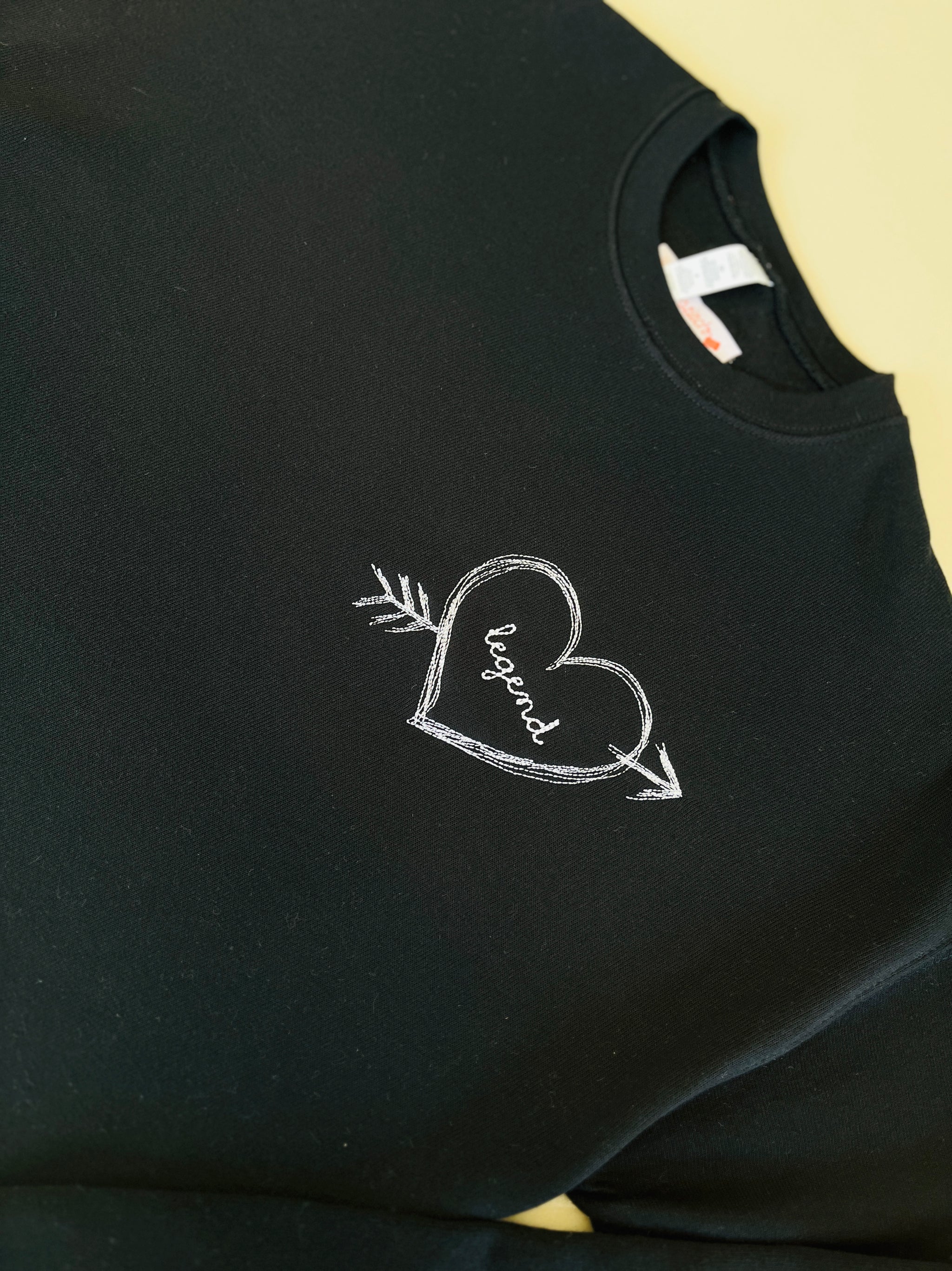 Personalized sweatshirt with heart and arrow embroidery