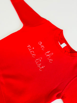 Holiday kids fleece sweatshirt with embroidered naughty or nice text