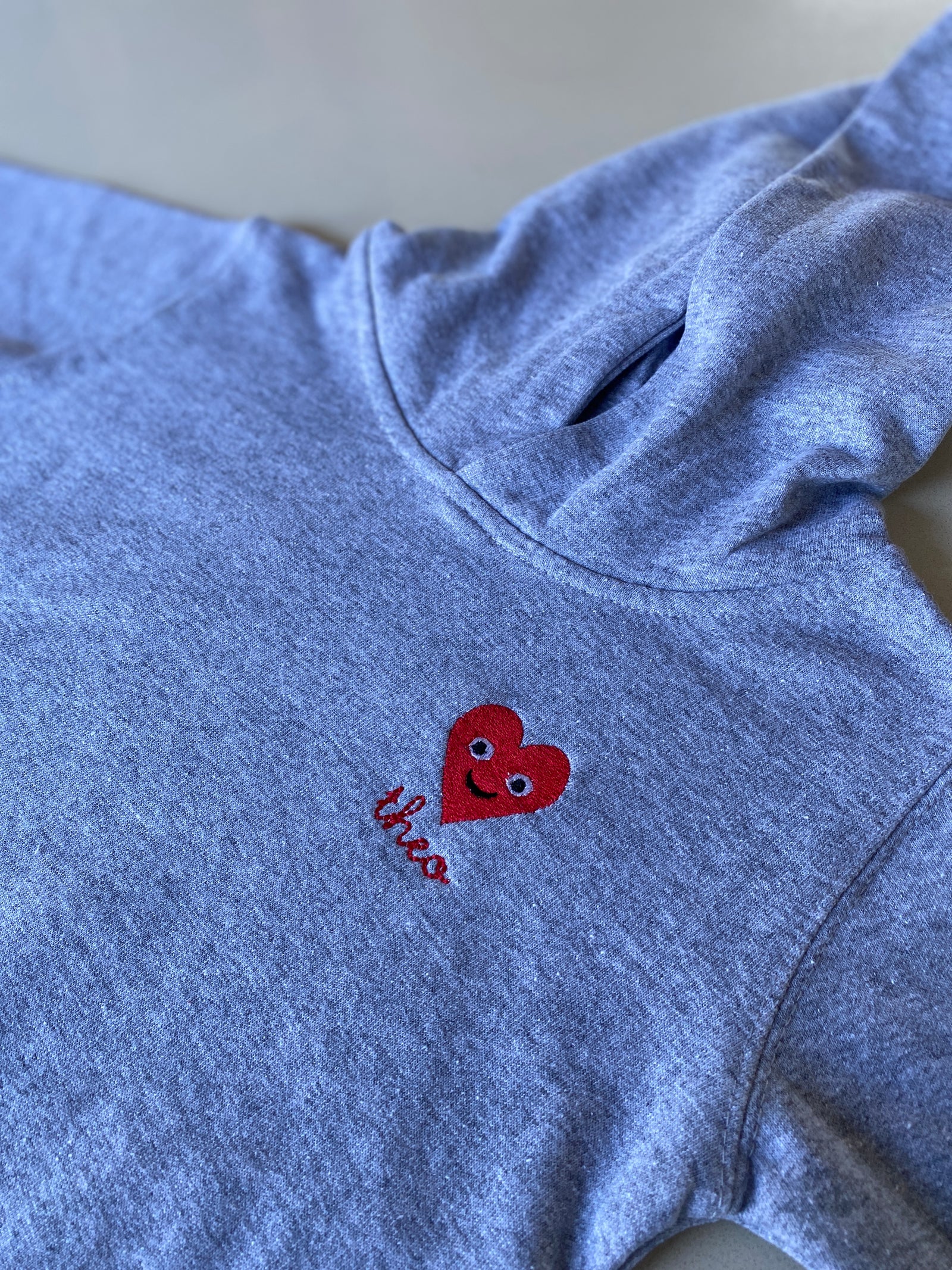 Valentine’s Day kids hoodie – personalized red smiley heart design