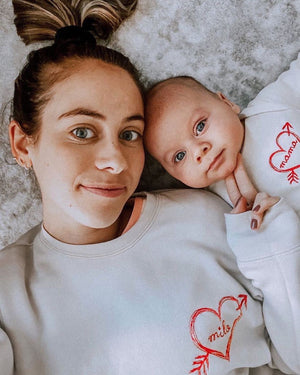 Personalized sweatshirt and onesie with heart and arrow embroidery